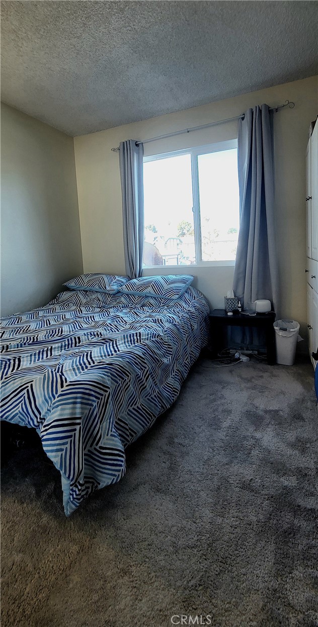 19221 Sherman Way, Unit 6 Reseda, CA 91335 - Photo 28 of 35 a bed sitting in a room next to a window