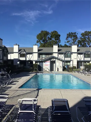 a view of a swimming pool with a table and chairs
