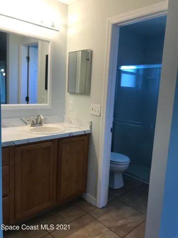 a bathroom with a sink a toilet and mirror