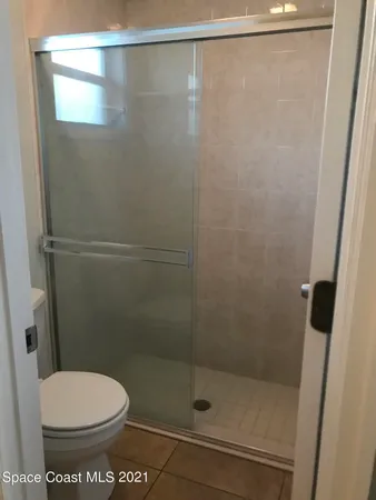 a bathroom with a shower and a toilet