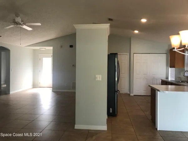 a view of a kitchen with a sink and a refrigerator