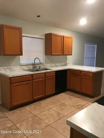 a kitchen with a sink a stove and cabinets