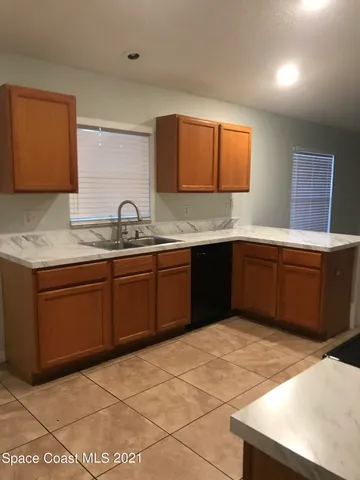 a kitchen with a sink a stove and cabinets