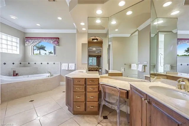 a spacious bathroom with a granite countertop sink mirror and bathtub