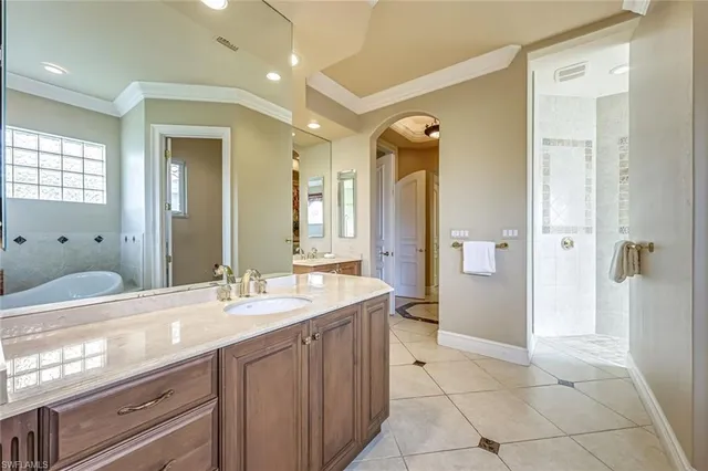 a bathroom with a double vanity sink mirror and shower