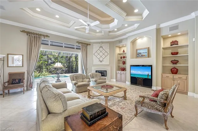 a living room with fireplace furniture and a large window