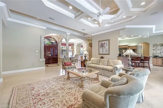 a living room with furniture and a chandelier