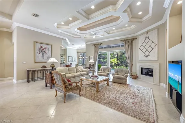 a living room with furniture large window and a fireplace