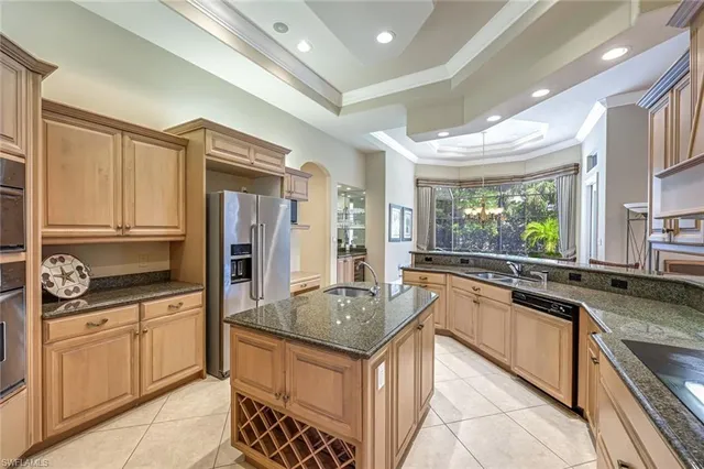 a kitchen with granite countertop a sink stove and refrigerator
