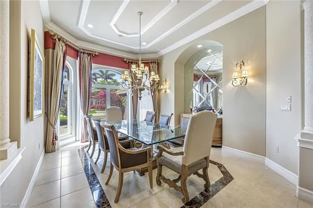 a dining room with furniture a chandelier and a rug