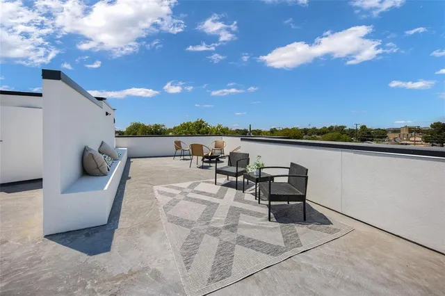 a terrace with outdoor seating and city view