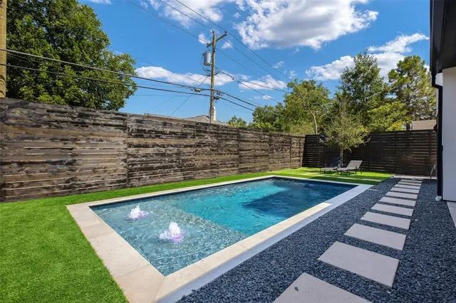 a view of a pool with a yard