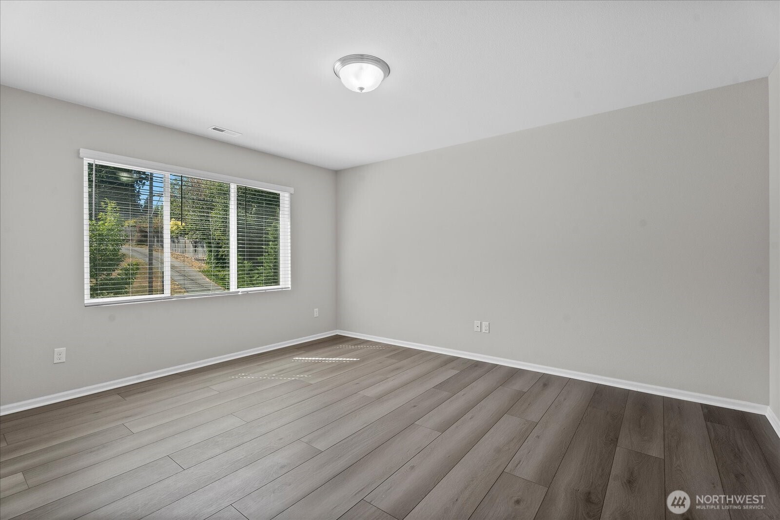 9901 13th Street Southeast Lake Stevens, WA 98258 - Photo 28 of 37 an empty room with wooden floor and windows