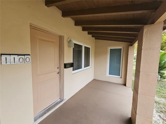 a view of a hallway with wooden floor and entryway