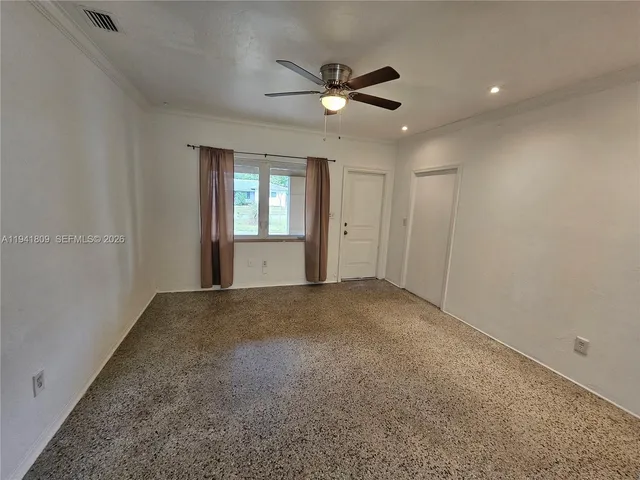 a view of a livingroom with a ceiling fan and window