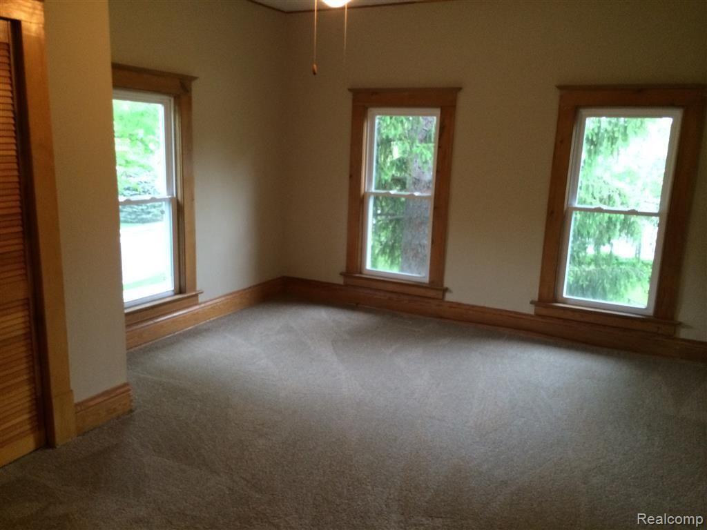 923 Jones Street Howell, MI 48843 - Photo 17 of 27 Bedroom with newer carpet and many windows let in lots of natural light.