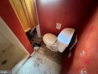 13813 Maple Tree Lane Southwest Cumberland, MD 21502 - Photo 8 of 26 a bathroom with a toilet and a mirror