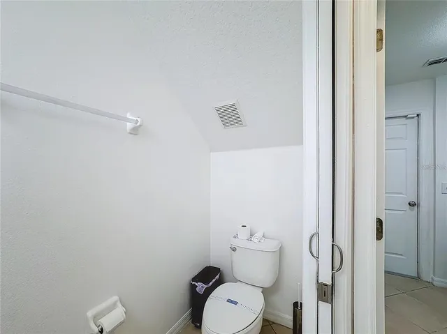 a white toilet sitting next to a bathroom sink