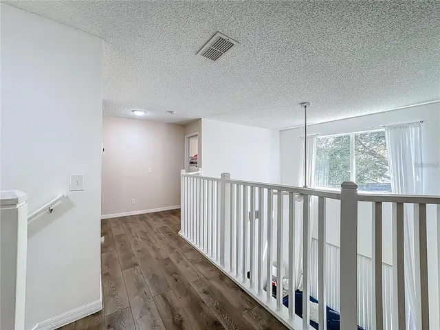 a view of hallway with wooden floor
