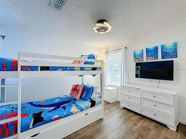 a bedroom with furniture and a flat screen tv