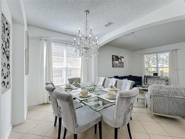 a view of a dining room with furniture windows and chandelier