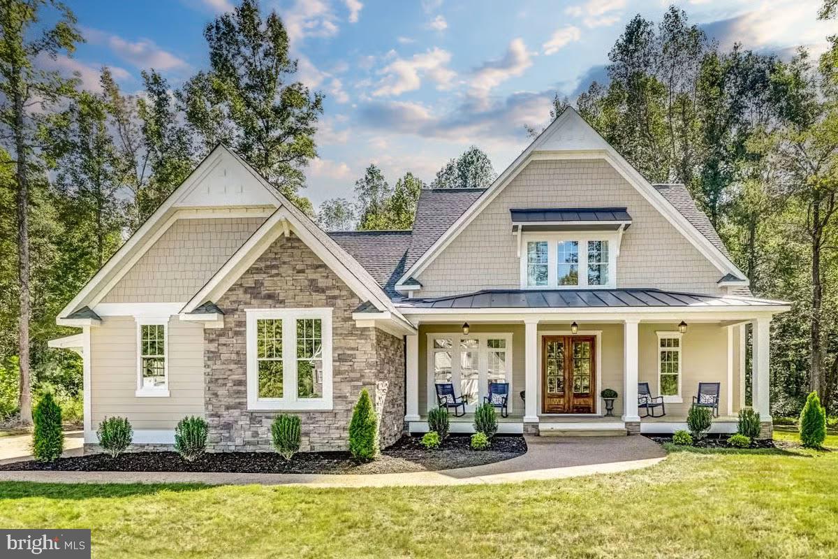 a front view of a house with swimming pool and porch with furniture