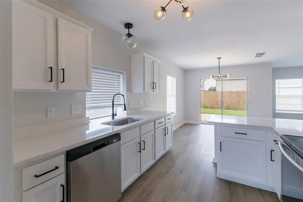 a kitchen with a sink cabinets and window