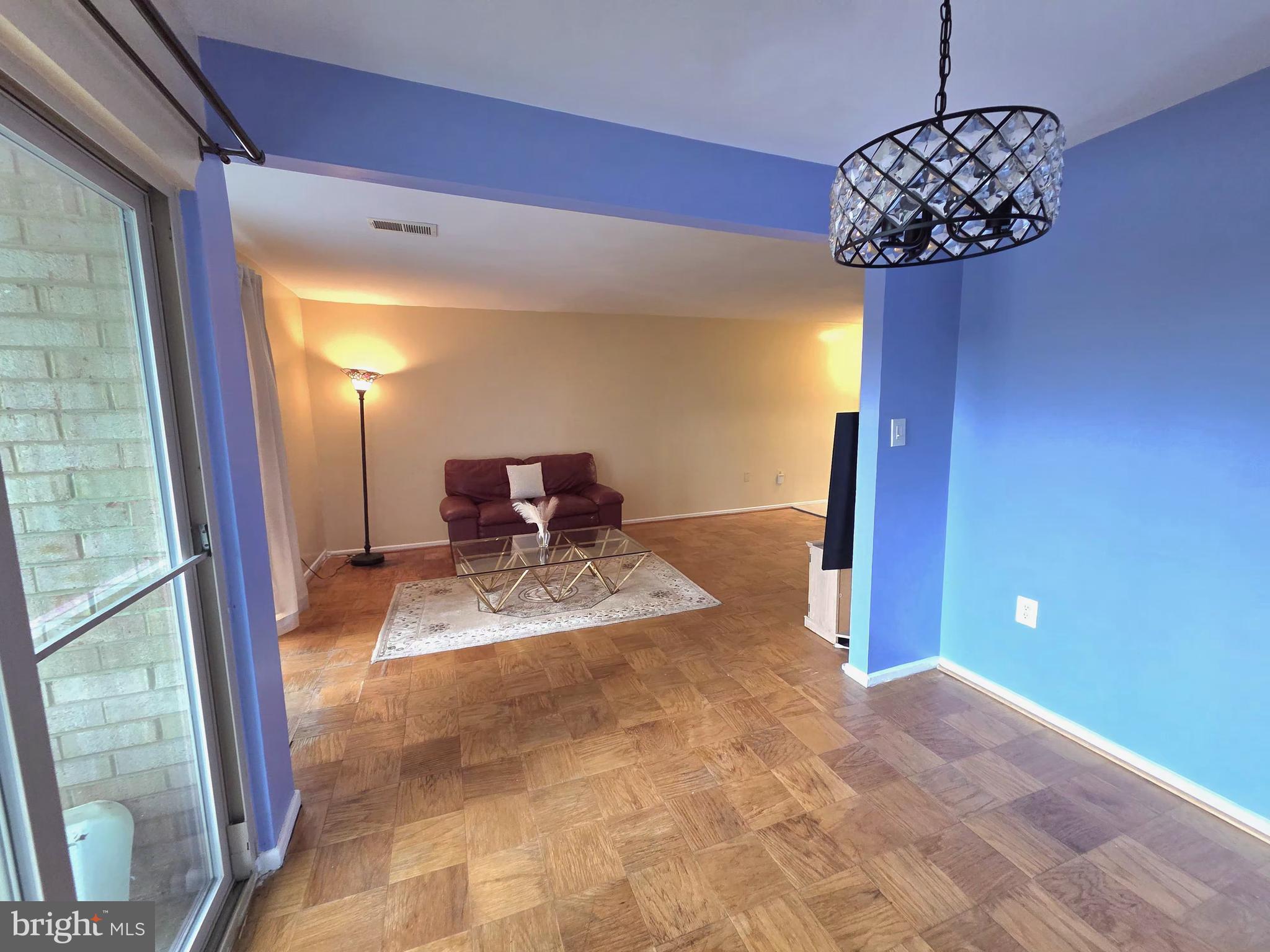 2302 Greenery Lane, Unit 30116 Silver Spring, MD 20906 - Photo 11 of 34 a view of a hallway to a livingroom with furniture