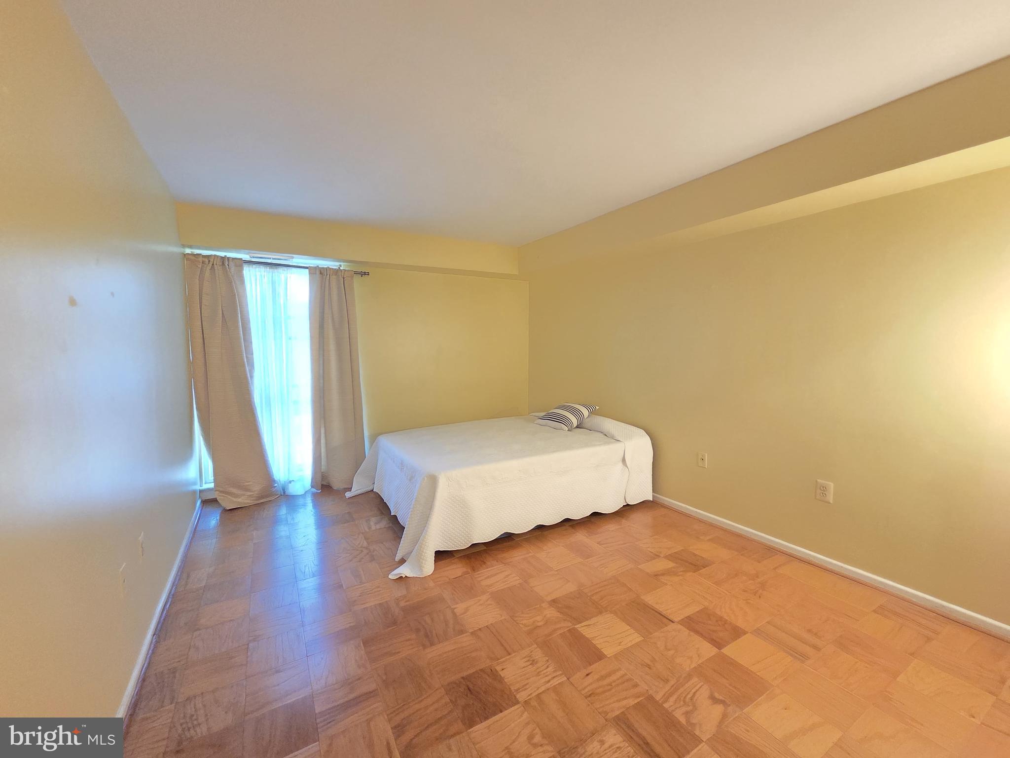 2302 Greenery Lane, Unit 30116 Silver Spring, MD 20906 - Photo 20 of 34 a bedroom with a bed and a mirror