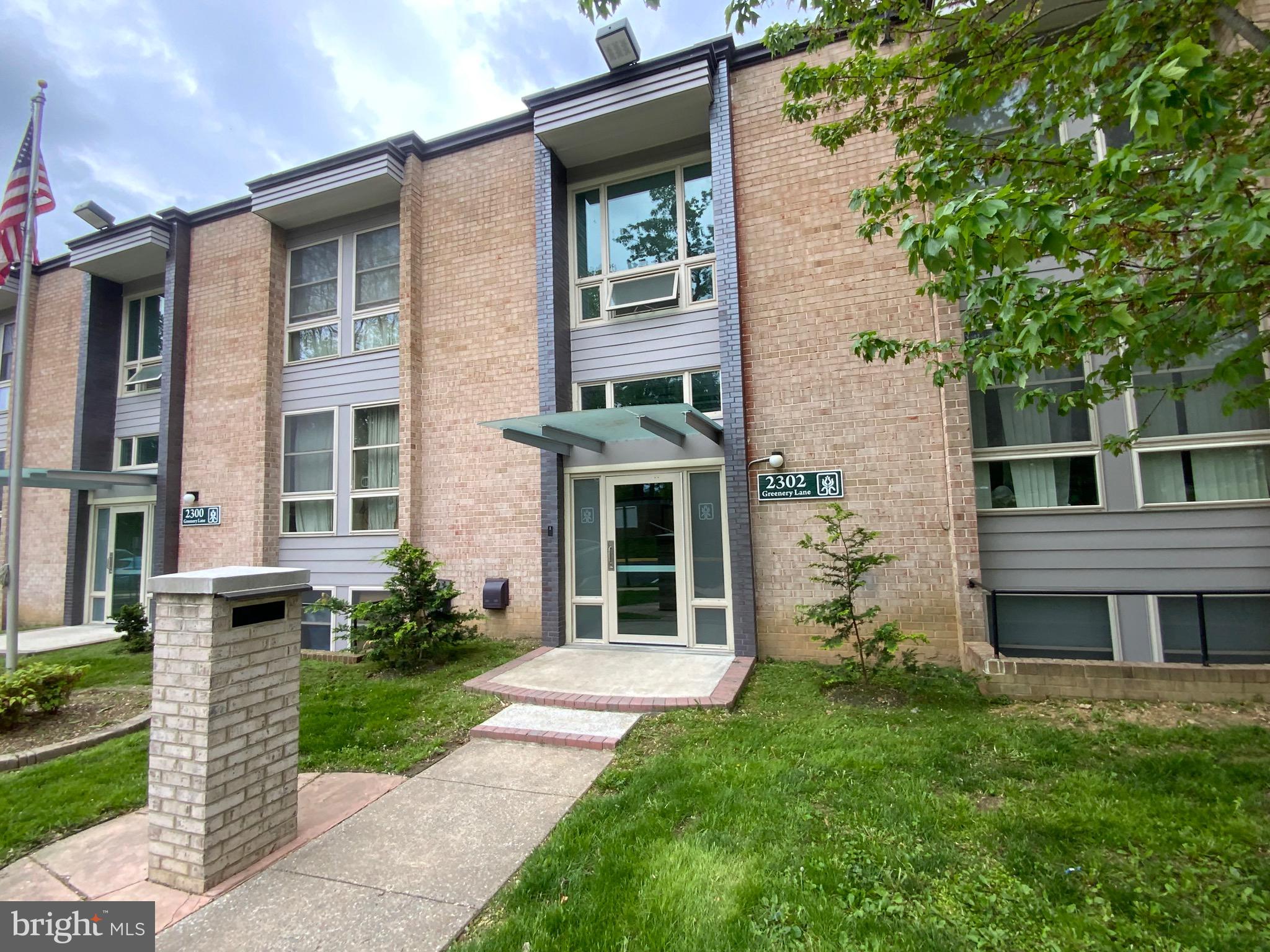 2302 Greenery Lane, Unit 30116 Silver Spring, MD 20906 - Photo 2 of 34 front view of a brick house with a yard