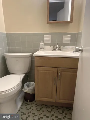 a bathroom with a sink toilet and mirror