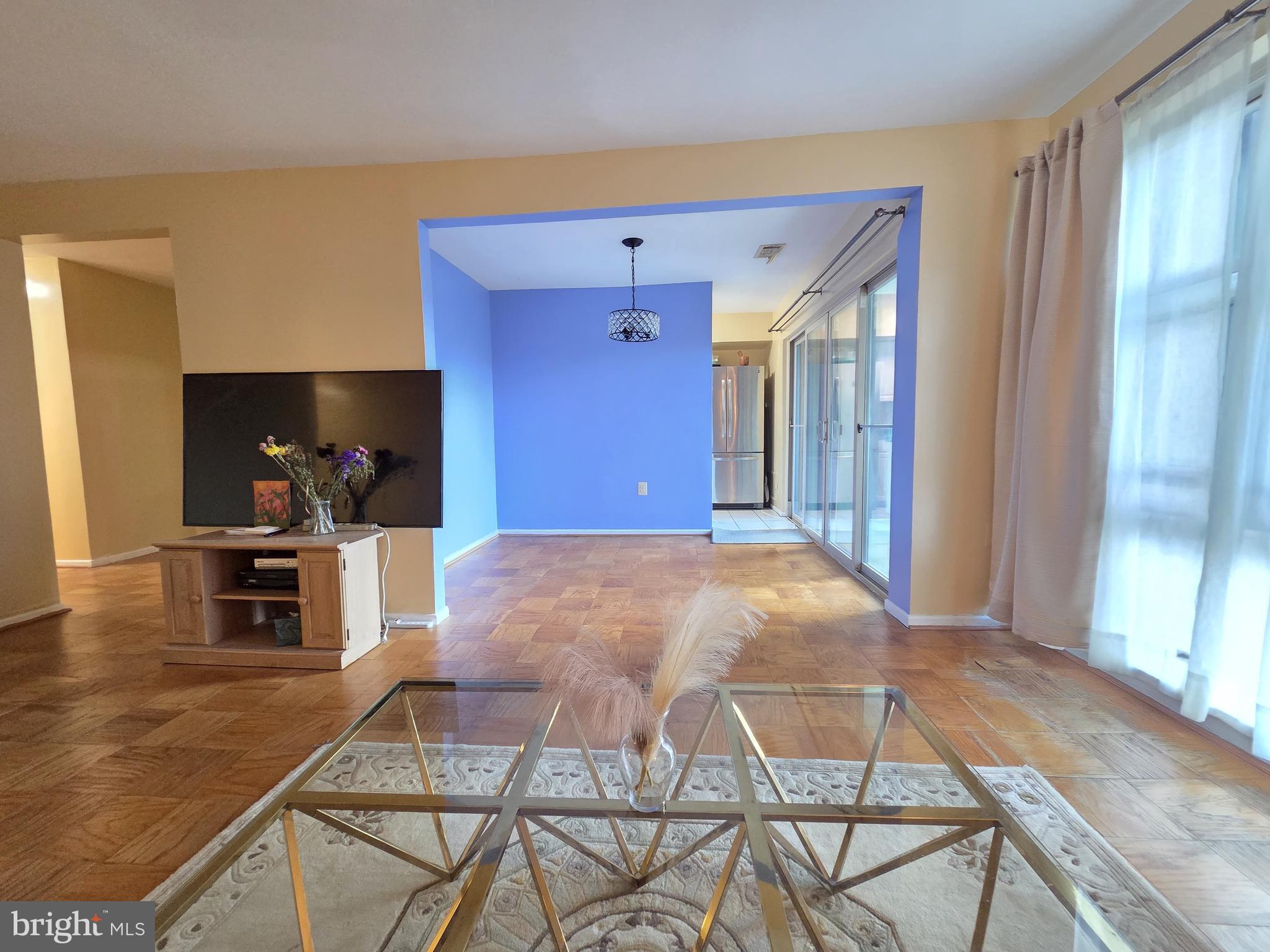 2302 Greenery Lane, Unit 30116 Silver Spring, MD 20906 - Photo 9 of 34 a living room with a dining table and chairs with wooden floor