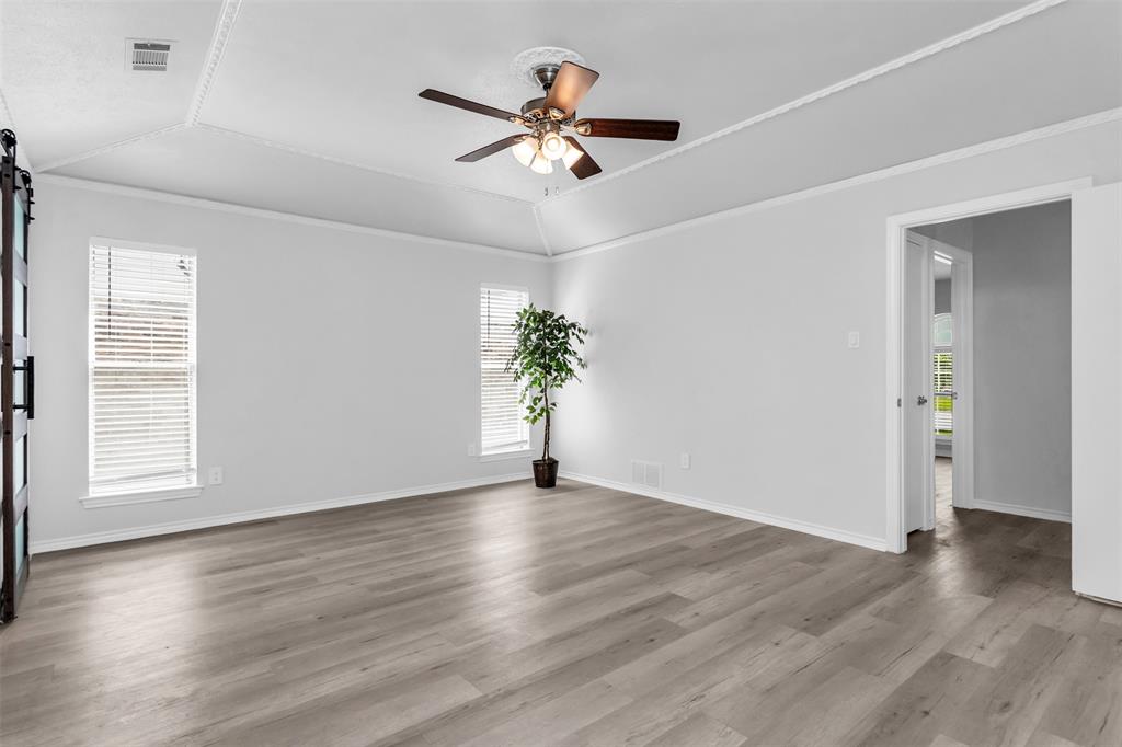 7233 Rustic Valley Drive Dallas, TX 75248 - Photo 17 of 21 a view of an empty room with wooden floor and a window