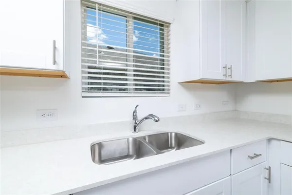 a bathroom with a sink and a window