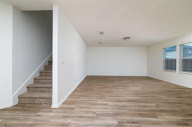 a view of an empty room with stairs and ventilation