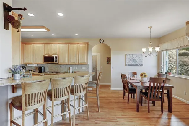 a kitchen with granite countertop white cabinets and stainless steel appliances