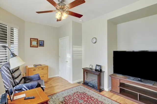 a view of a workspace with furniture and a window