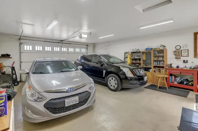 a view of a yard with trees on both side of the road