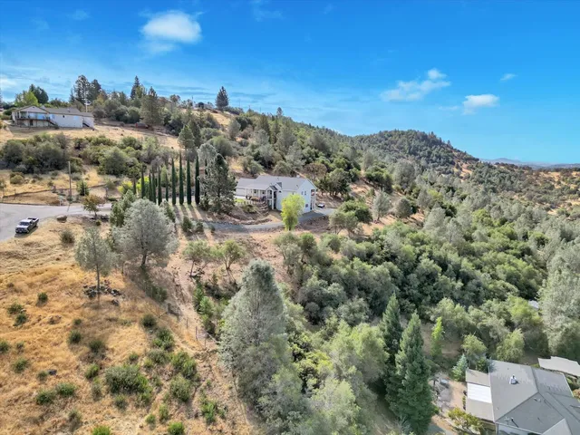 a view of a balcony with wooden floor & fence