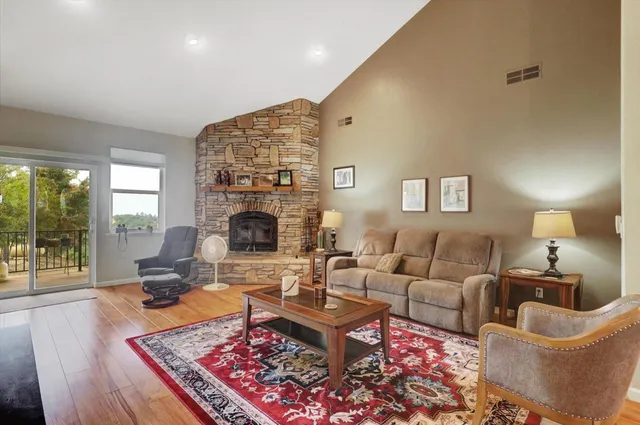 a living room with fireplace furniture and rug