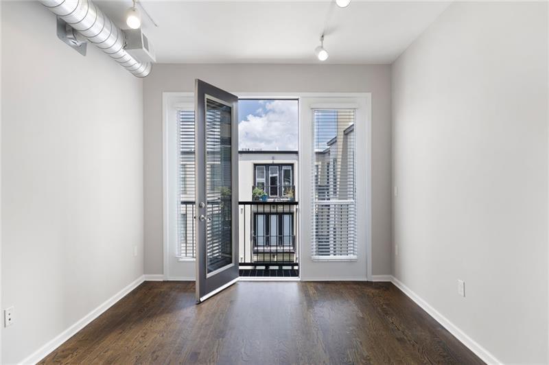 5300 Peachtree Road, Unit 3207 Chamblee, GA 30341 - Photo 11 of 25 an empty room with wooden floor and windows