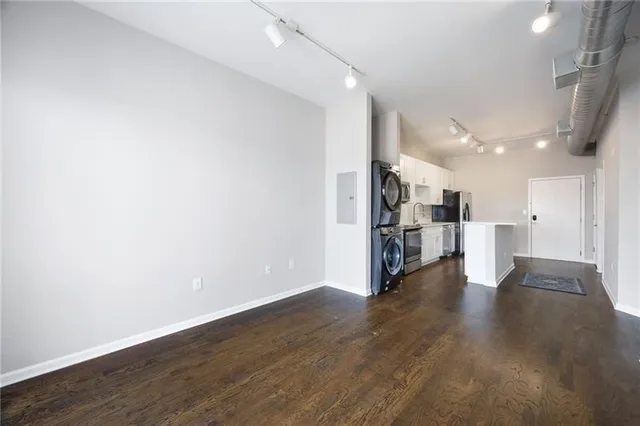 a view of a hallway with wooden floor