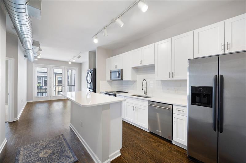5300 Peachtree Road, Unit 3207 Chamblee, GA 30341 - Photo 4 of 25 a kitchen with stainless steel appliances a sink stove and refrigerator