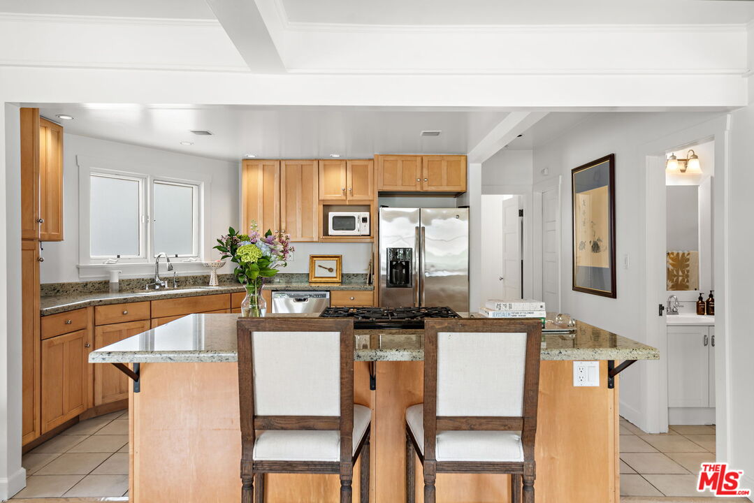 308 Windward Avenue Venice, CA 90291 - Photo 14 of 30 a kitchen with stainless steel appliances granite countertop a sink and a refrigerator