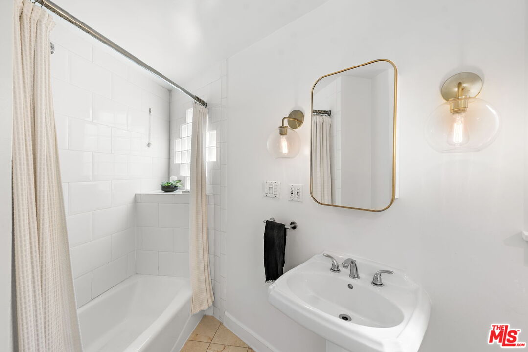 308 Windward Avenue Venice, CA 90291 - Photo 18 of 30 a bathroom with a sink and a mirror
