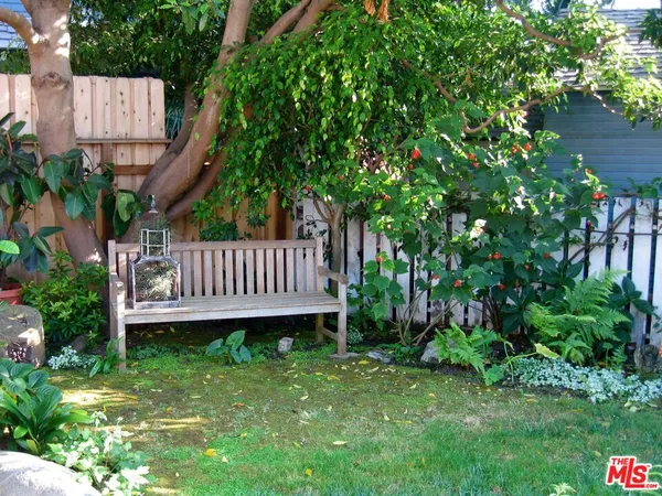 a view of a backyard with a deck and a garden
