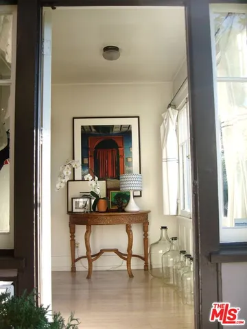a living room with furniture large window and a table