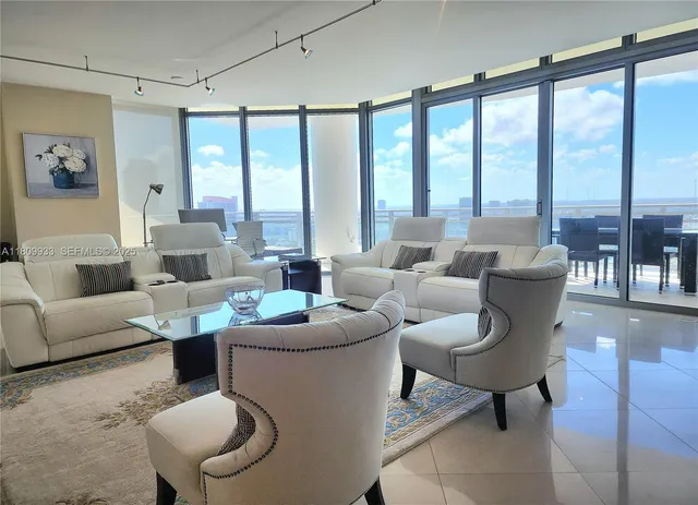 a view of a room with furniture and a floor to ceiling window