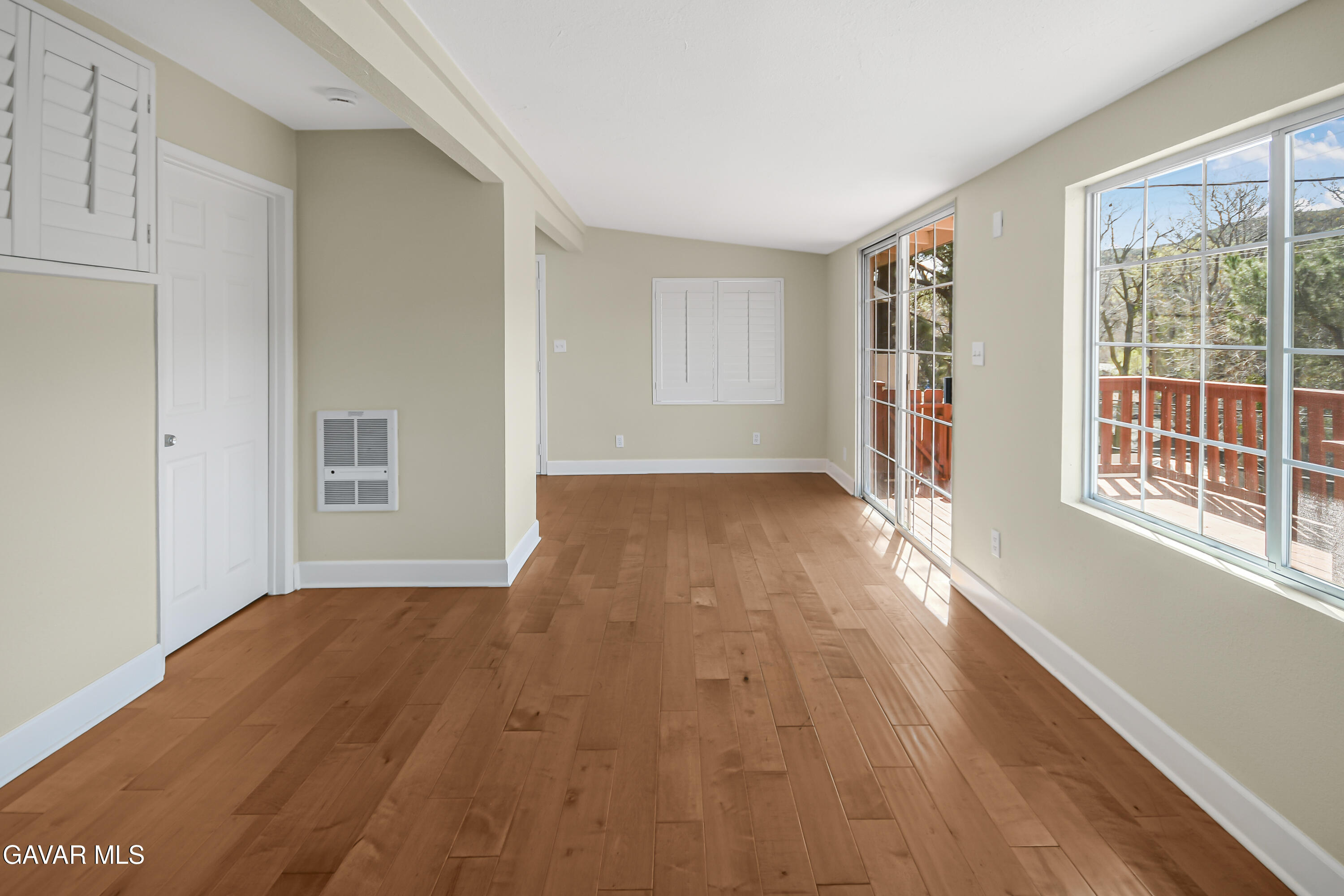 17743 Elizabeth Lake Road Lake Hughes, CA 93532 - Photo 6 of 33 a view of an empty room with wooden floor and a window