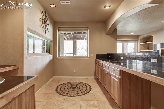 20 Keithley Road Manitou Springs, CO 80829 - Photo 29 of 42 Lower level wet/dry bar with tile flooring with custom tile in-lay.